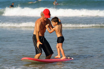 Photo of boy getting his first surfing lesson