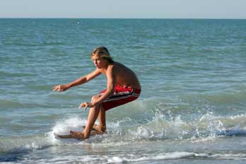 skim boarder at New Brighton Beach, Santa Cruz County, CA